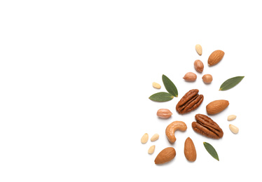 Photo of Different delicious nuts on white background, flat lay. Space for text