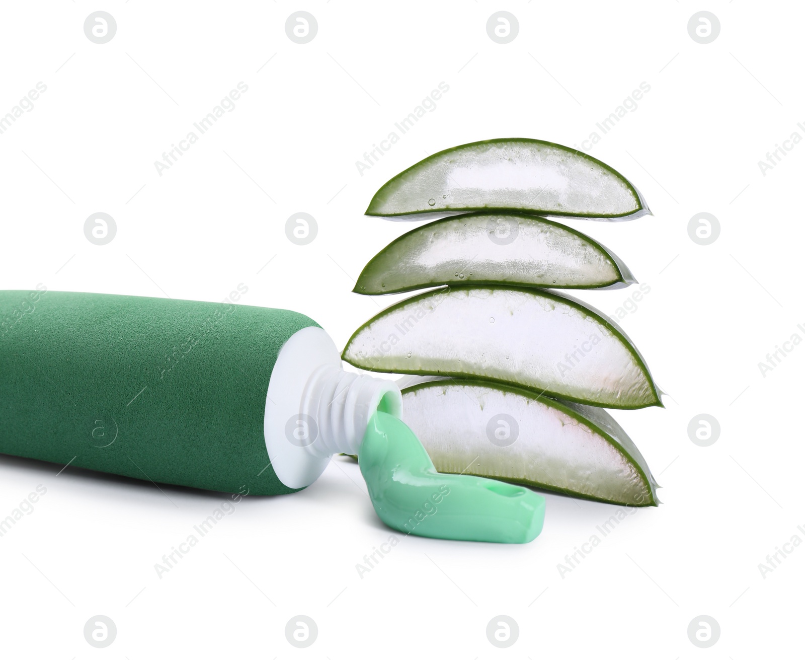 Photo of Open tube of toothpaste with cut aloe vera on white background