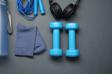 Photo of Sports equipment, socks and headphones on grey background, flat lay