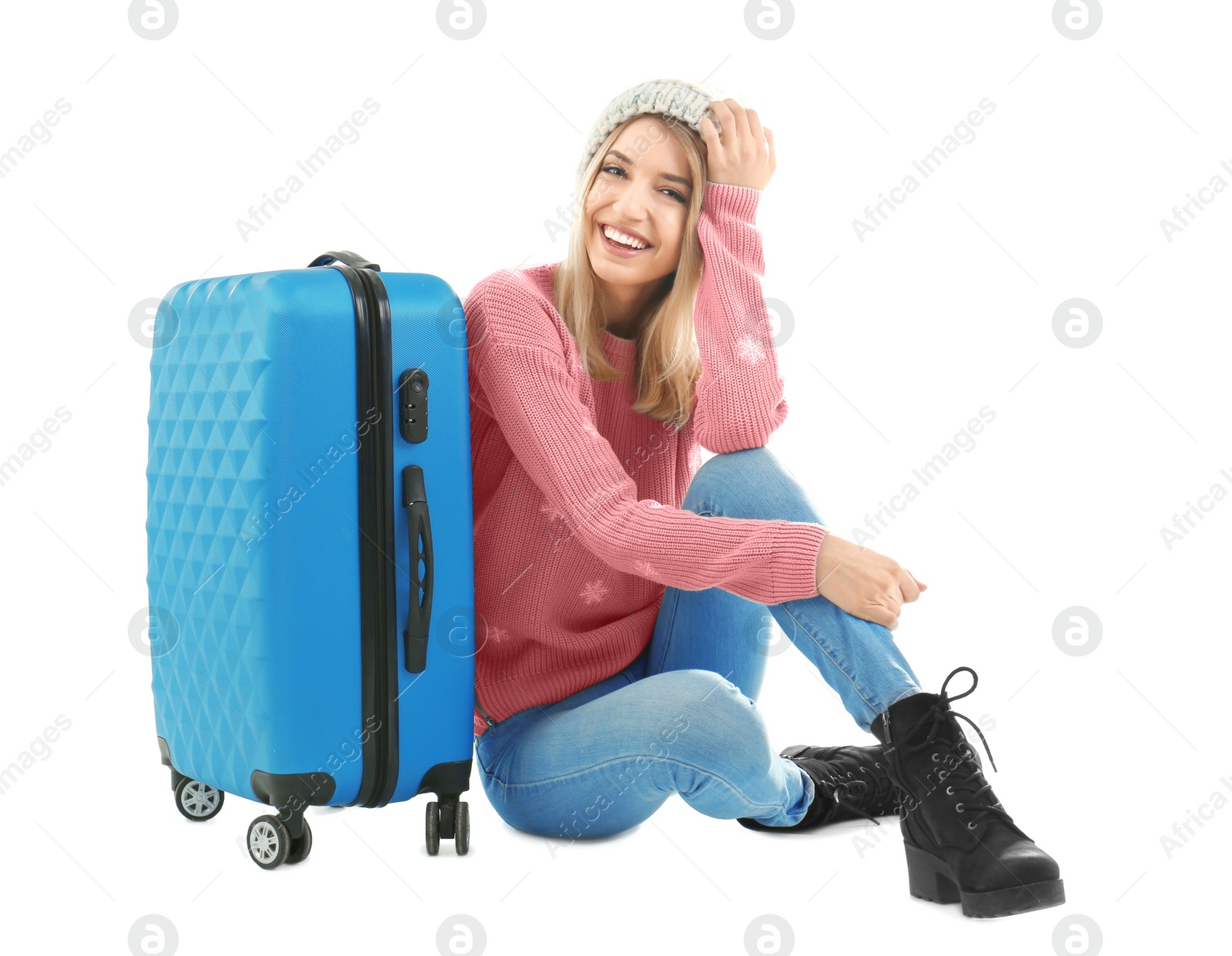 Photo of Young woman with suitcase on white background. Ready for winter vacation