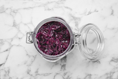 Photo of Tasty red cabbage sauerkraut on white marble table, top view