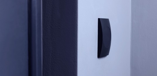 Photo of Magnetic door lock on light wall. Home security