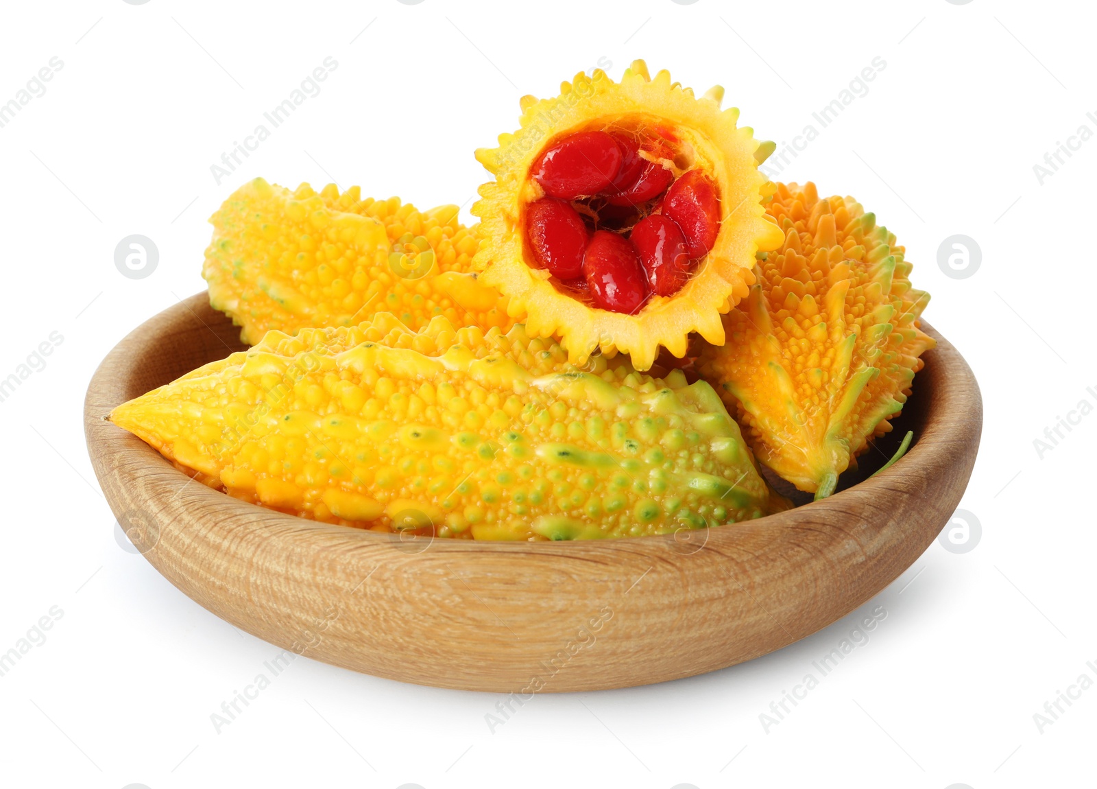 Photo of Wooden bowl with fresh ripe bitter melons on white background