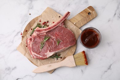 Photo of Raw meat, rosemary, marinade and spices on white marble table, top view