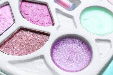 Photo of Decorative cosmetics for kids. Eye shadow palette as background, closeup