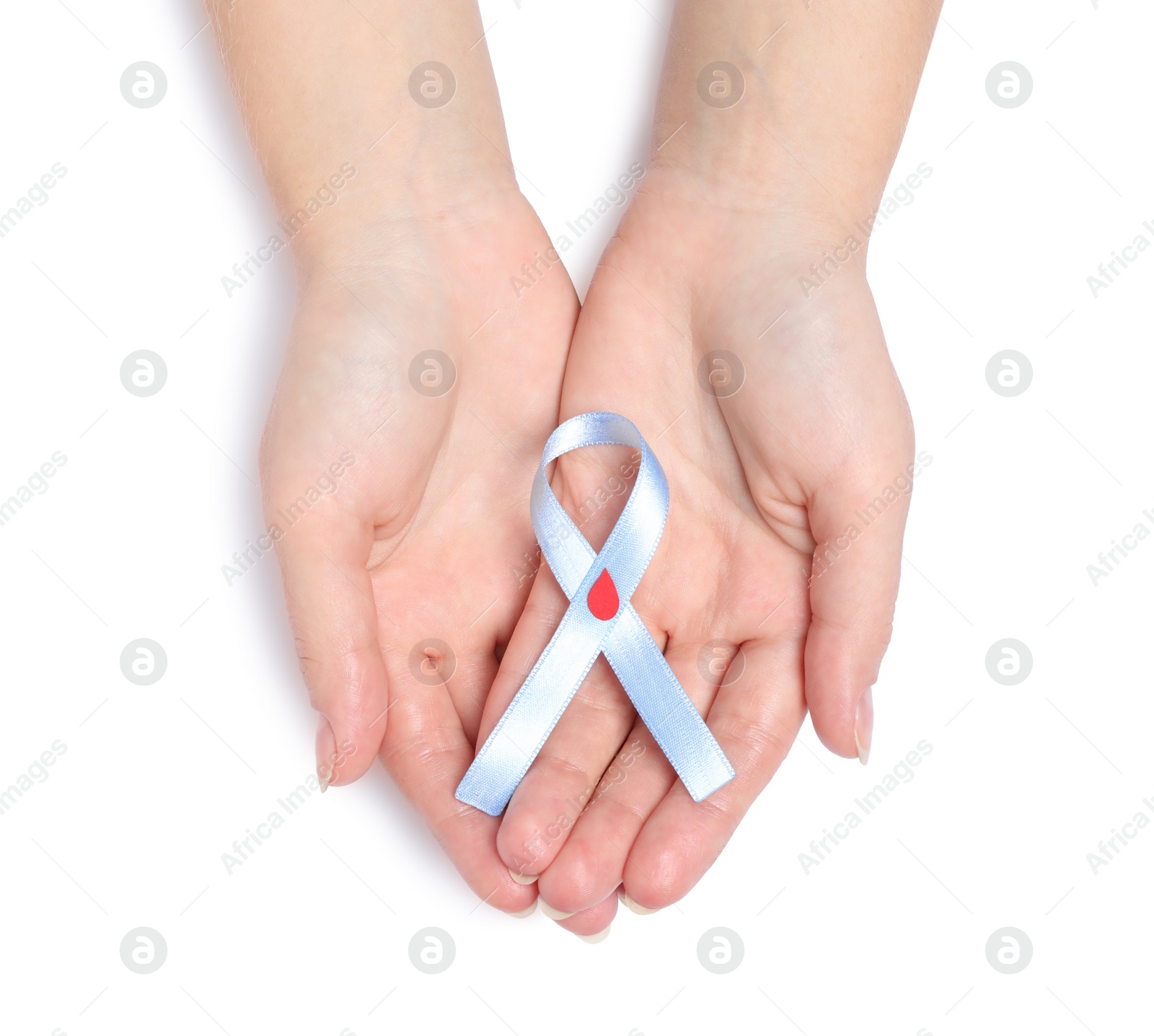 Photo of Woman holding light blue ribbon with paper blood drop on white background, top view. World Diabetes Day