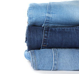 Stack of different jeans isolated on white