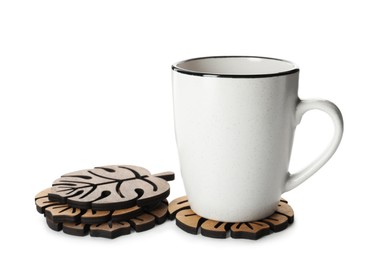 Mug and stylish wooden coasters on white background