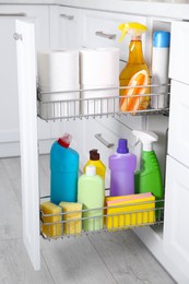 Open drawer with different cleaning supplies in kitchen