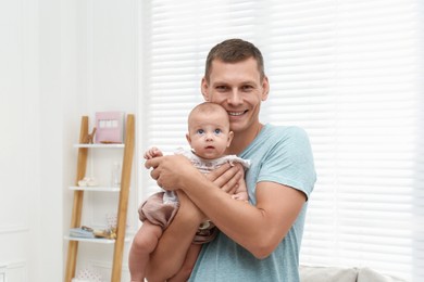 Photo of Happy father with his little baby at home