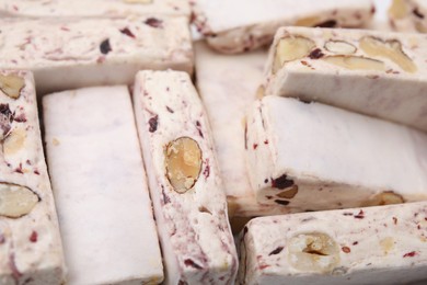 Photo of Pieces of delicious nougat as background, closeup