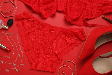 Flat lay composition with sexy lingerie on red background