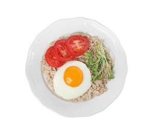 Delicious boiled oatmeal with fried egg, tomato and microgreens isolated on white, top view