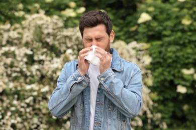 Photo of Man suffering from seasonal pollen allergy on spring day