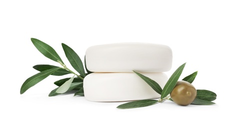 Photo of Soap bars and leaves with olive on white background