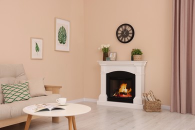 Photo of Stylish fireplace near comfortable sofa and coffee table in cosy living room