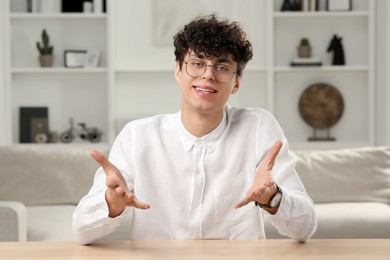 Young man having online video call at home, view from web camera