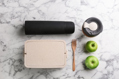 Flat lay composition with thermos on white marble table