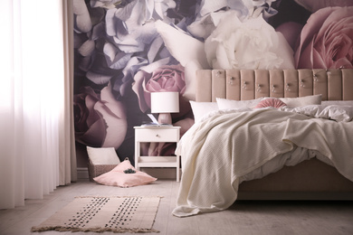 Photo of Stylish floral room interior with comfortable bed