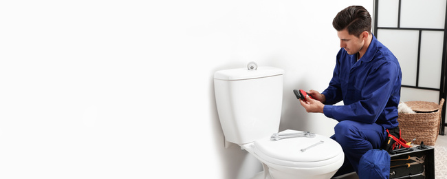 Image of Professional plumber working with toilet bowl in bathroom, space for text. Banner design