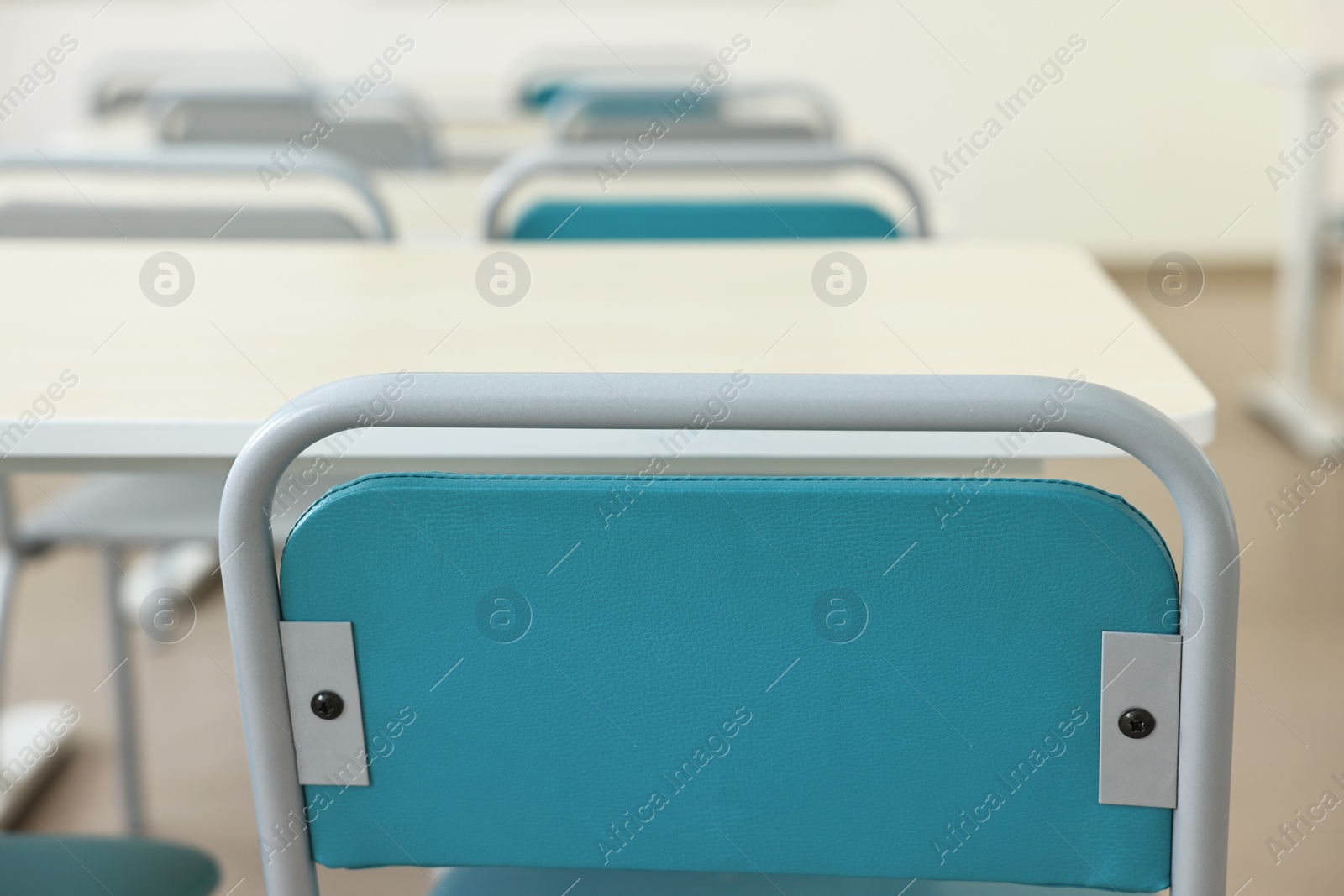 Photo of Empty school classroom with desks and chairs