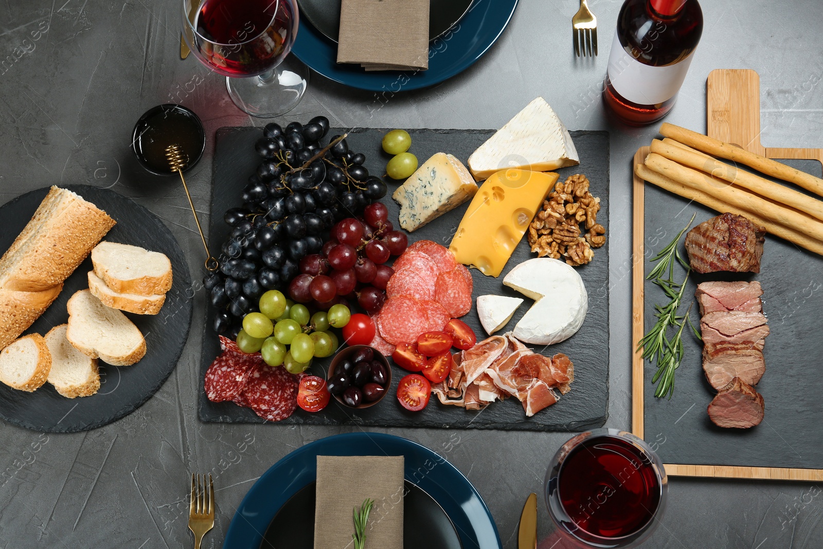 Photo of Wine and snacks served for dinner on table in restaurant, flat lay