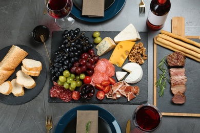 Wine and snacks served for dinner on table in restaurant, flat lay