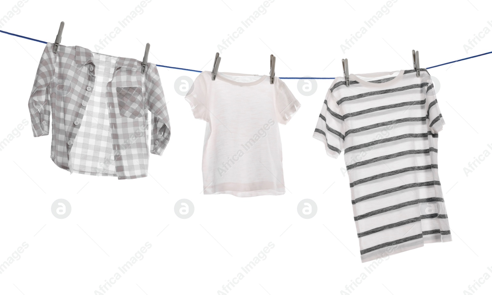 Photo of Different clothes drying on washing line against white background