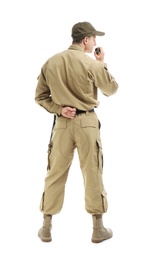 Male security guard using portable radio transmitter on white background