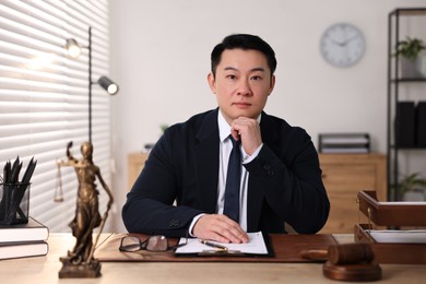 Photo of Notary working at wooden table in office