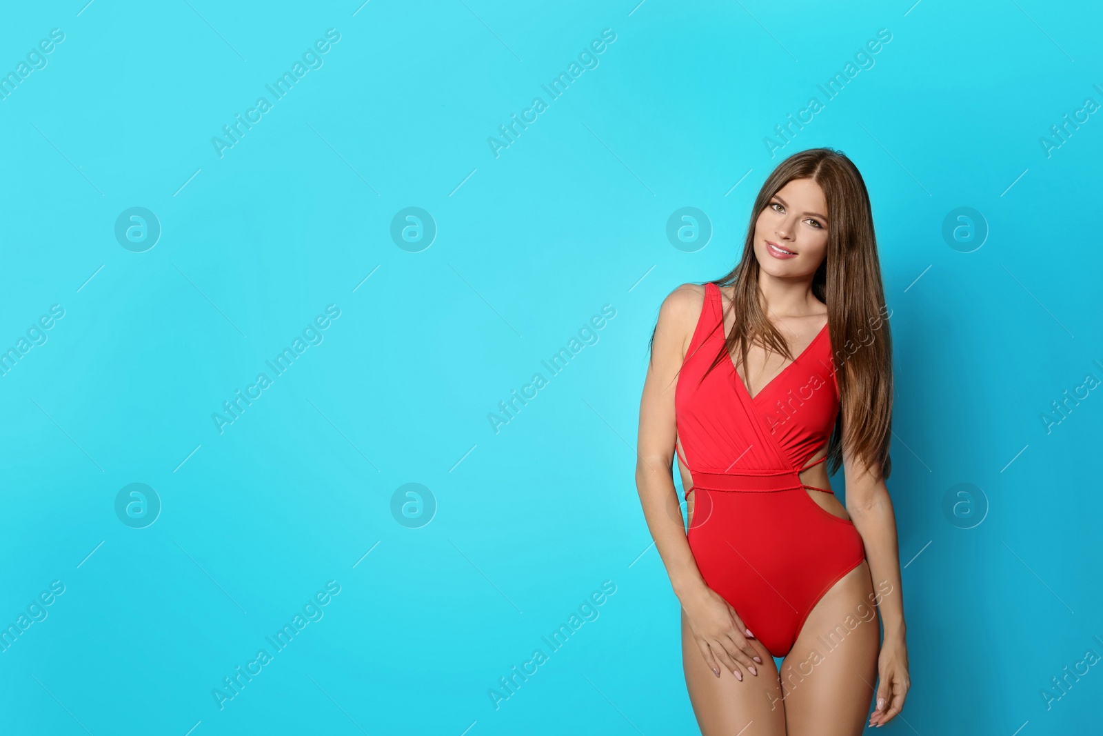 Photo of Sexy young woman in bikini on color background