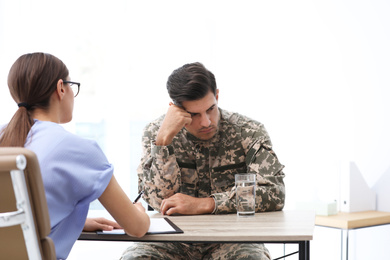 Psychotherapist working with male military officer in office