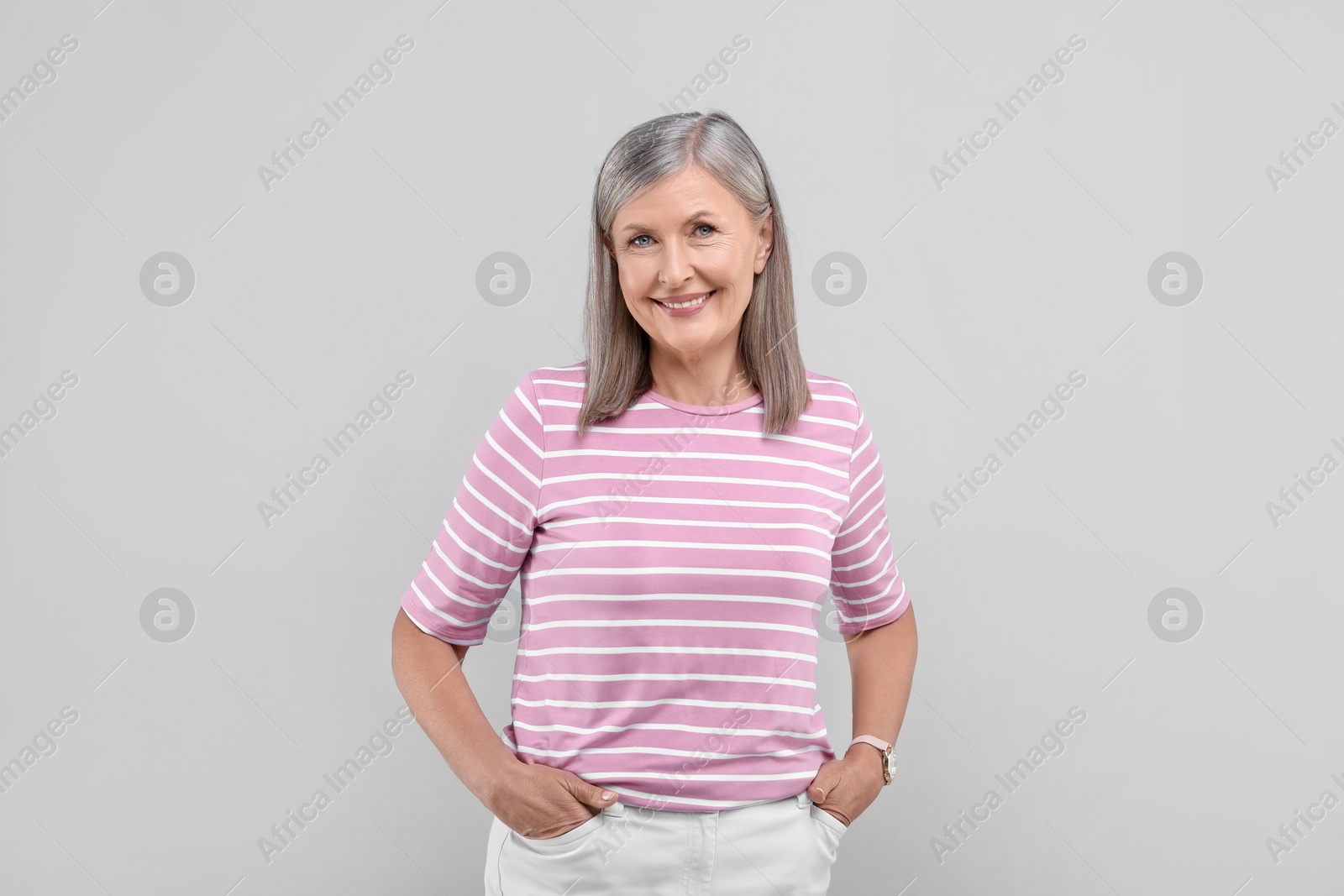 Photo of Portrait of beautiful senior woman on light grey background