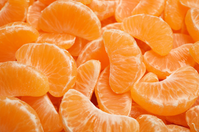 Photo of Fresh juicy tangerine segments as background, closeup