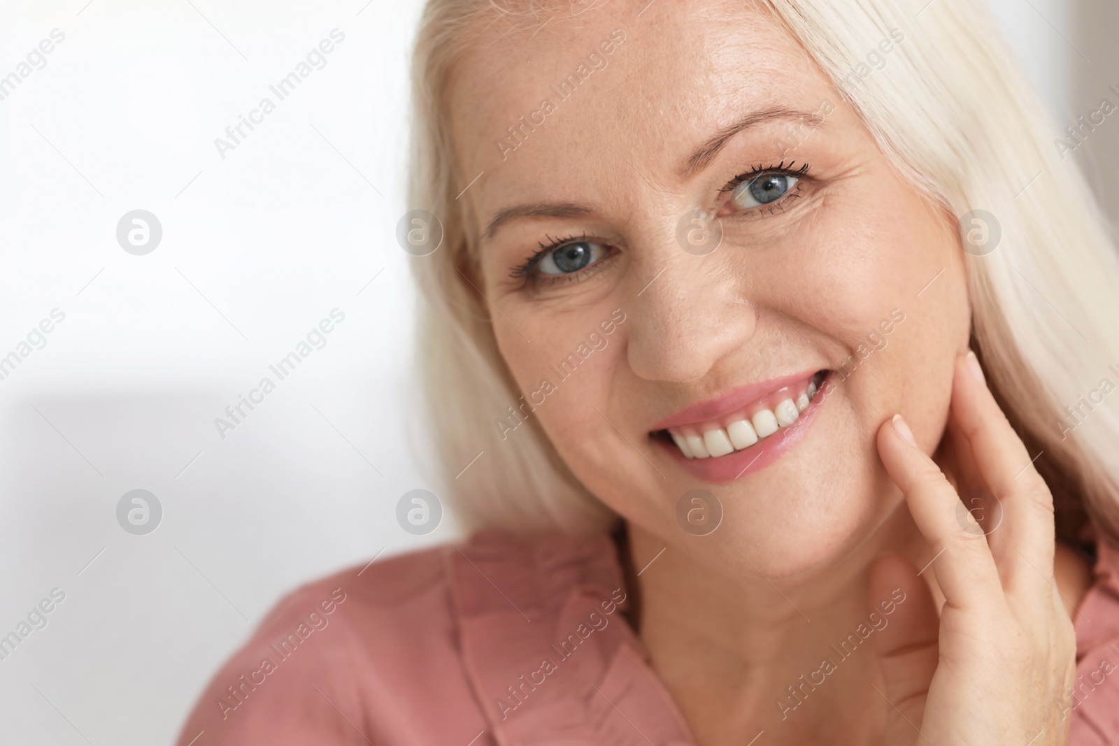 Photo of Portrait of beautiful older woman against light background