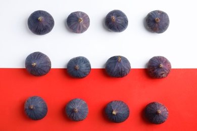 Delicious ripe figs on color background, flat lay