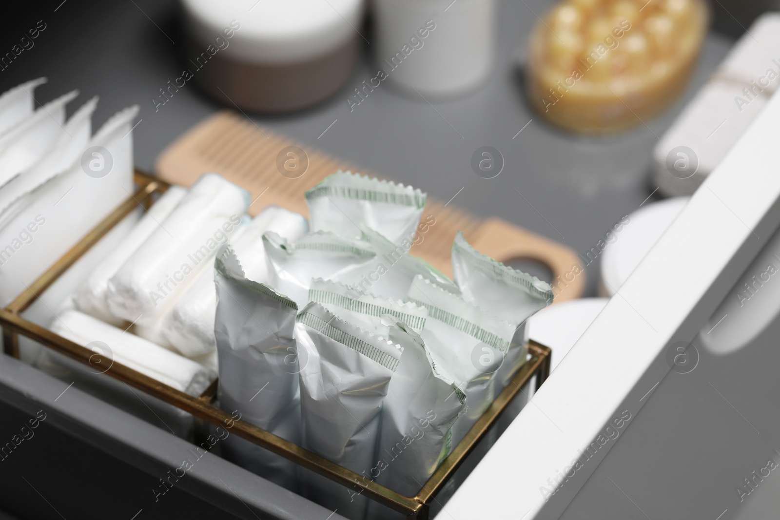 Photo of Storage of different feminine hygiene products in drawer, closeup