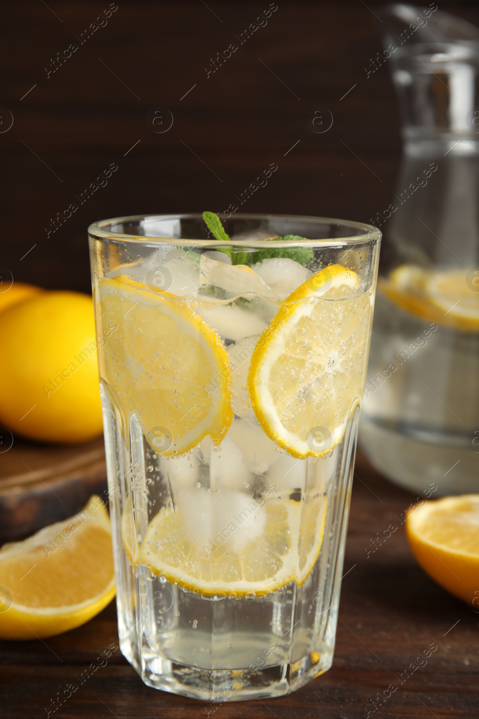 Photo of Cool freshly made lemonade on wooden table