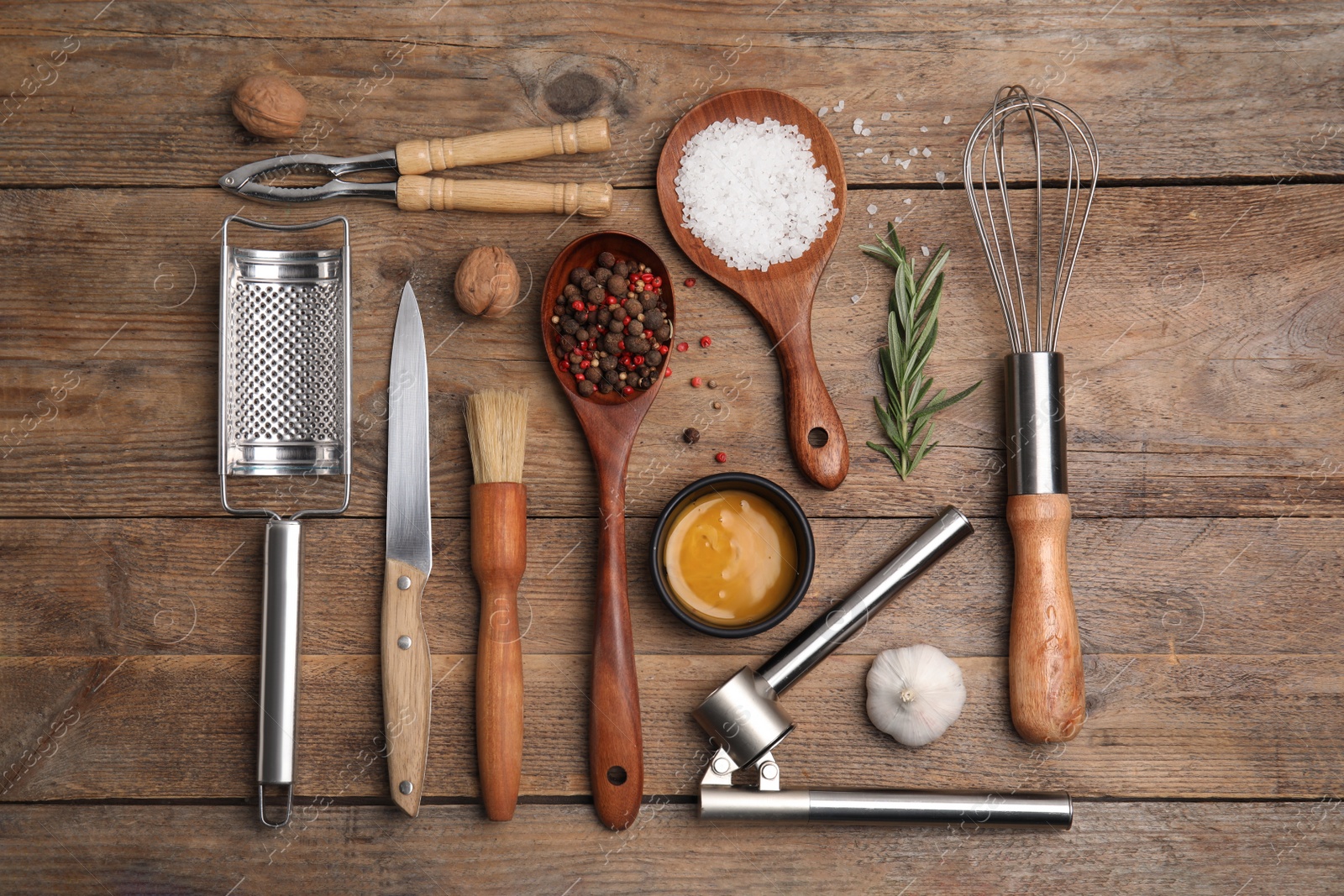 Photo of Flat lay composition with cooking utensils and ingredients on wooden table