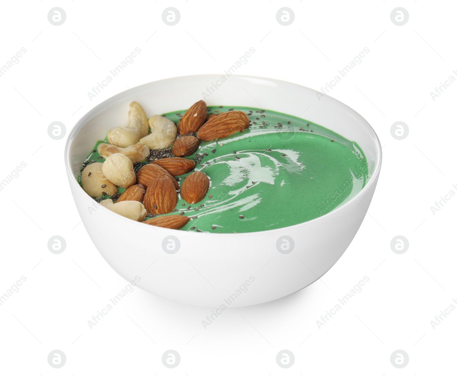 Photo of Bowl of spirulina smoothie with nuts isolated on white