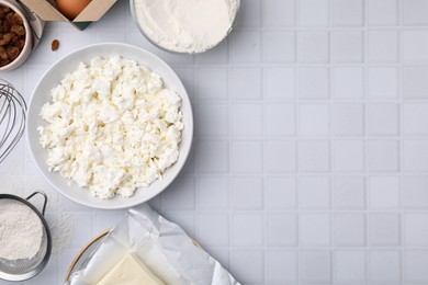 Photo of Different ingredients on white tiled table, flat lay and space for text. Cooking cottage cheese pancakes