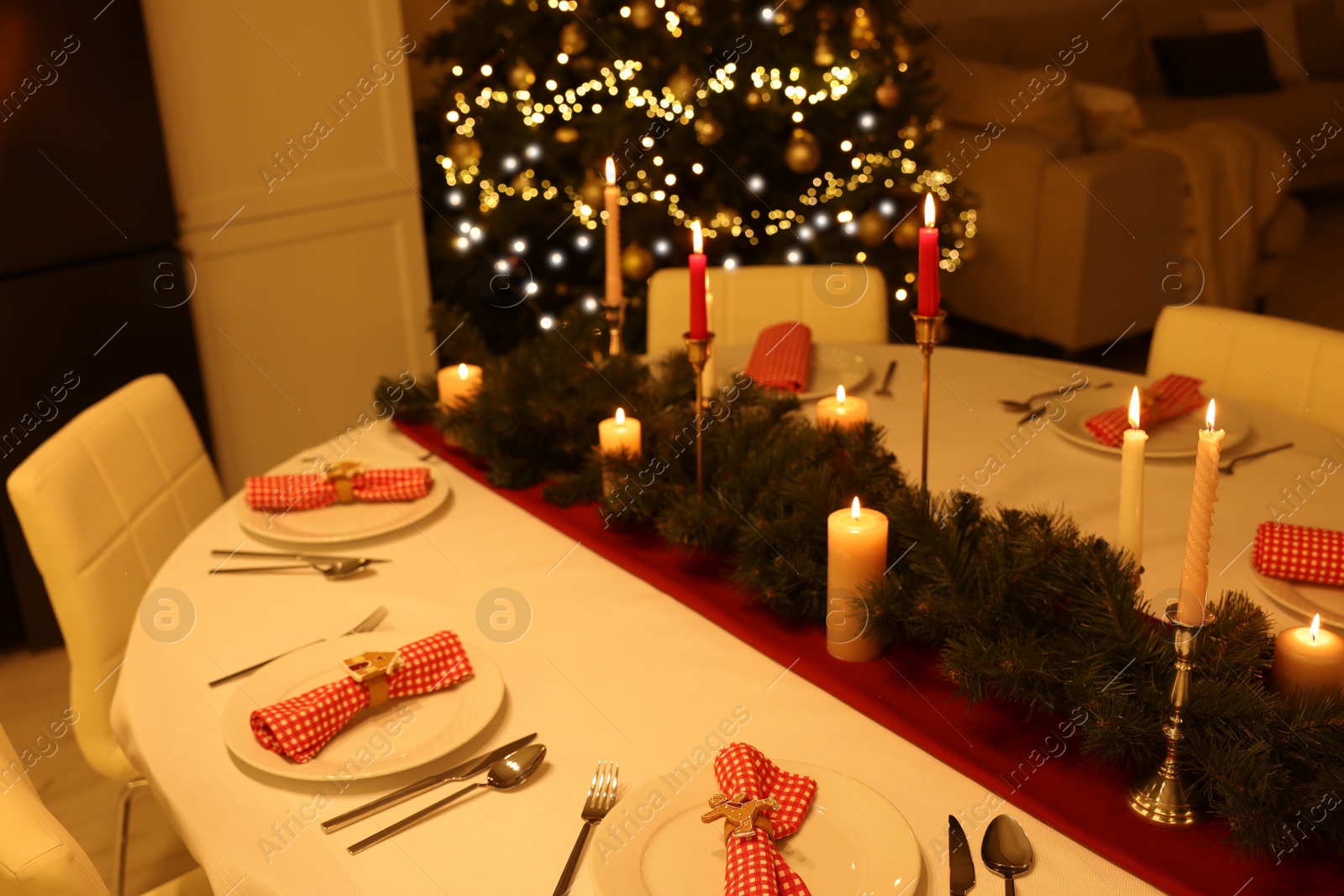 Photo of Festive table setting and beautiful Christmas decor in room. Interior design