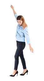 Photo of Full length portrait of businesswoman balancing on white background