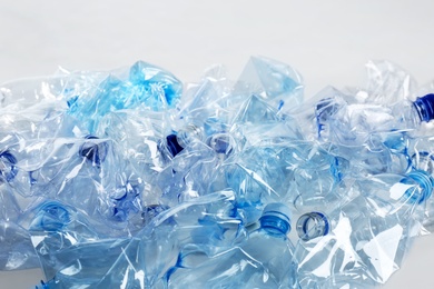 Photo of Heap of used plastic bottles on white background. Recycling problem