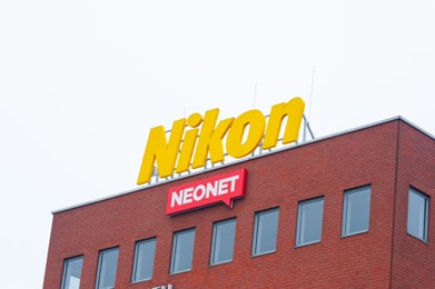 Photo of Warsaw, Poland - September 10, 2022: Building with modern Nikon and Neonet logos