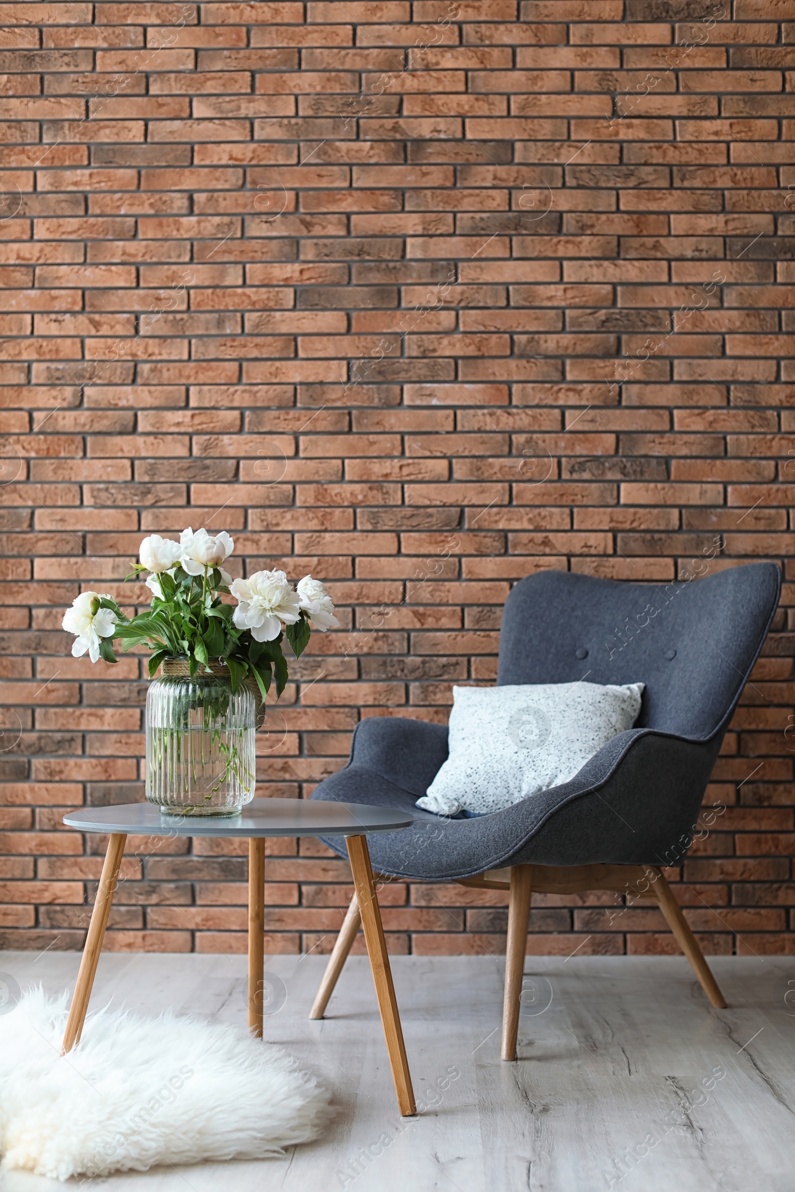 Photo of Room interior with armchair and beautiful flowers