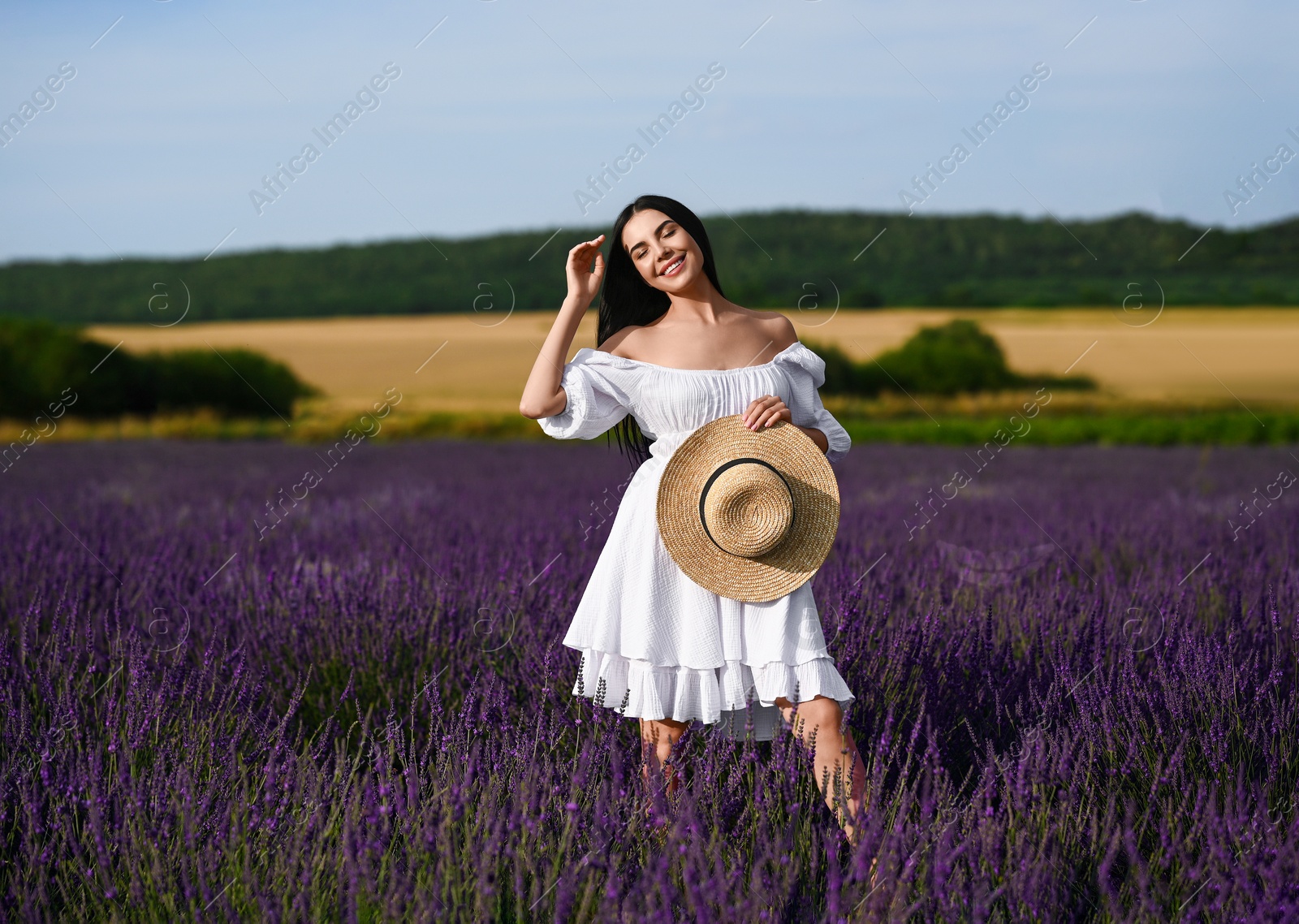 Photo of Beautiful young woman walking in lavender field