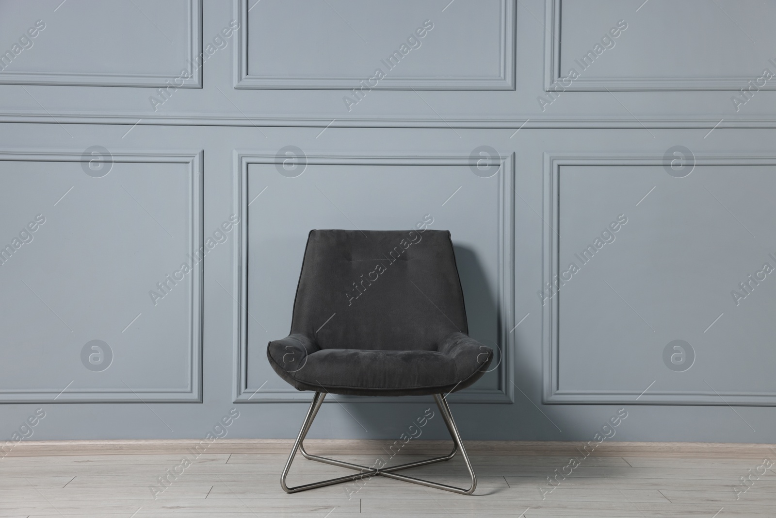 Photo of Comfortable armchair near grey wall in room