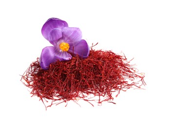 Photo of Pile of dried saffron and crocus flower on white background