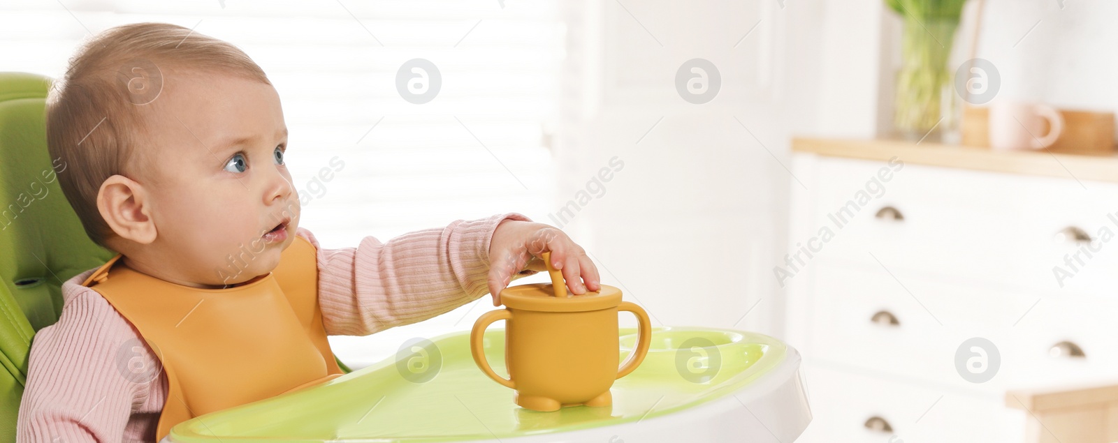 Image of Cute little baby wearing bib in highchair at home, space for text. Banner design